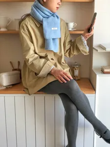 Cozy light blue knit winter scarf for women, soft wool warm neck wrap accessory.