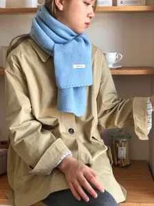 Cozy light blue wool knitted scarf for women, warm winter neckerchief and cold weather accessory.