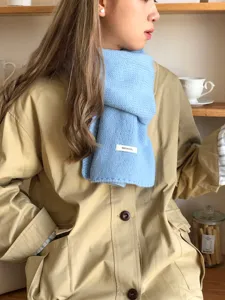 Solid blue knitted winter scarf detail view, elegant wool neck warmer for women use