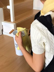 Detailed view of a cozy yellow knit scarf and matching gloves, perfect for winter warmth.