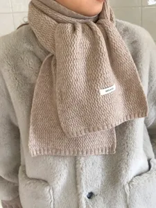 Minimalist wool scarf detail, warm winter knit shawl, soft beige texture for women, chic style.