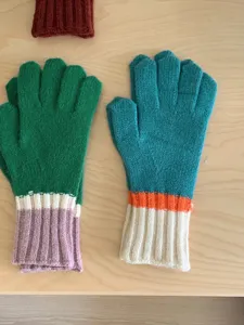 Detailed view of women's autumn winter colorblock knit five-finger gloves warm cozy accessory.