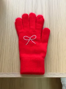 Red knit gloves for women featuring a sparkling rhinestone bow and heart detail for winter warmth.