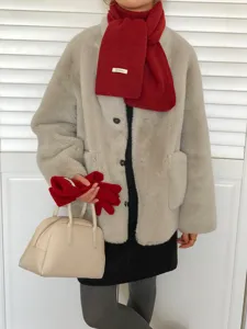 Cozy solid red wool scarf paired with winter wear, detailed view of warm fabric and texture.