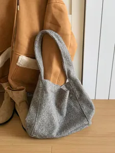 Grey textured wool tote bag detail showing soft boucle fabric and large capacity design.