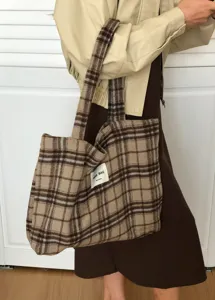 Detailed view of the winter wool plaid tote bag showing texture, stitching and brand label design.