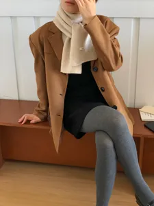 Cozy winter knitted scarf paired with elegant outerwear, perfect for daily chic outfits.