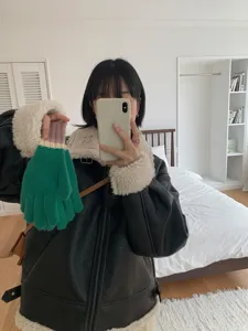 Detailed view of women's cozy color-blocked knit gloves, thick and warm for winter weather.