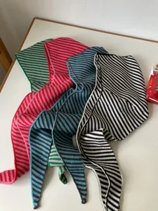 Detail shot of multi-color striped knitted scarves, warm and stylish winter accessories for women.