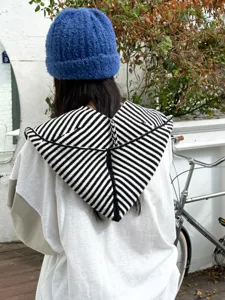 Detail view of the autumn winter knitted striped hood scarf and blue beanie hat for women warm