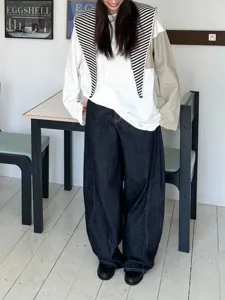 Women's autumn fashion long sleeve top with striped shawl collar and wide leg jeans.