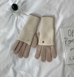 Detail view of stylish color block knit gloves, long design, warm and comfortable for winter.
