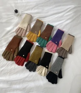 Detailed view of colorful color-blocked winter knit touch screen gloves with warm long cuffs.