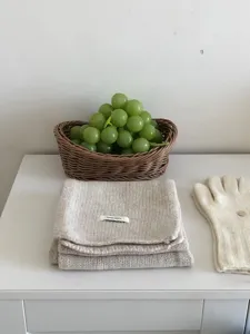 Close-up of beige knitted wool scarf detail, soft texture and warm winter accessory scene display.
