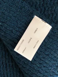 Detailed close-up showing soft knit wool texture and care label of winter warm scarf.