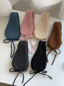 Winter warm plush ear muffs with cute drawstring design, soft fleece ear warmers for women.