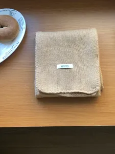 Solid color wool knit scarf detail view, winter warm soft neck warmer accessory for women.