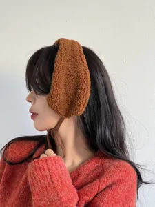 Cozy brown plush earmuffs for women, cute winter warm fluffy ear warmers with soft ties.