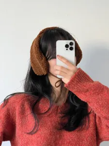 Fluffy winter earmuffs detail, soft fleece ear warmers for women, cozy cold weather accessory.