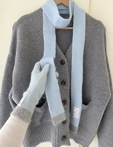 Détail d'écharpe en tricot bleu clair et gants tactiles en douce fourrure de lapin.
