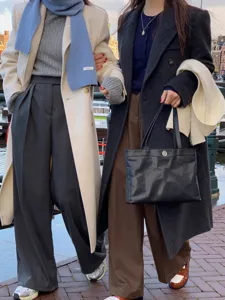 Detail shot of cozy winter wool scarf and stylish seasonal outerwear in street scene setting.