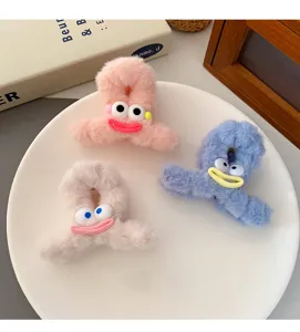 Cute plush hair claw clip for women, fluffy shark clip with funny face design, small size for hair.