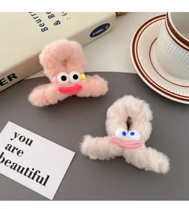 Cute plush hair claw clip with smiling face cartoon design, soft fuzzy winter hair accessories.