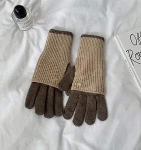 Close-up detail of cozy color-block knit gloves showing soft textured fabric and cuffs.