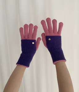 Color-block knit gloves detail view, featuring stylish winter warm gloves with metal button.