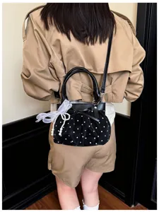 Black polka dot ruched underarm bag for women, stylish single shoulder crossbody handbag.