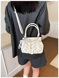 Chic white polka dot shoulder bag with pearl bow pendant for women summer daily commute.