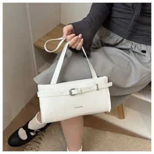 White patent leather shoulder bag detail, stylish underarm handbag with decorative buckle.