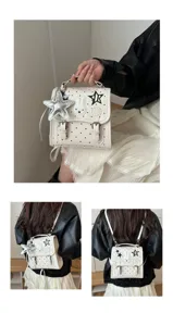 Vue détaillée du sac à dos à pois blancs avec lapin en peluche et pendentifs étoiles.