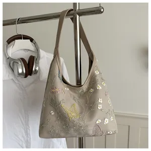 Bolso de hombro beige bordado con delicadas flores y mariposas para mujer estilo casual.