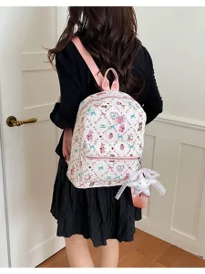 Zaino carino in stile giapponese con stampa di cartoni animati per donne e studenti con cinghie rosa.