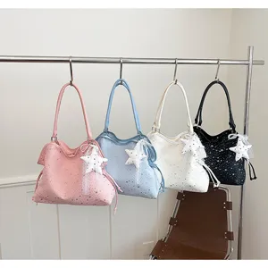 Detailed showcase of the stylish star rhinestone tote bag featuring a cute lace pendant.
