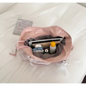 Detailed top view of pink leather tote bag interior with large capacity and storage space.