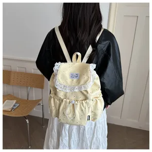 Joli sac à dos jaune à imprimé étoiles et jolie bordure en dentelle, idéal pour l'école.