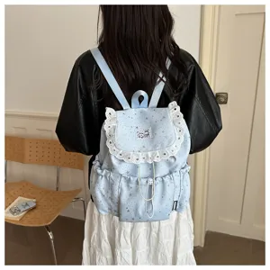 Sac à dos cordon motif étoiles bleu clair avec volants en dentelle blanche, cartable.