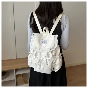 Sac à dos mignon blanc à motif d'étoiles avec bordure en dentelle pour voyage quotidien.