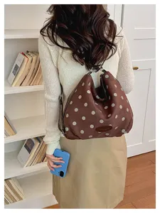 Detail view of the retro brown suede polka dot backpack, showing soft fabric texture and straps.
