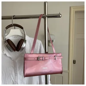 Stylish pink patent leather shoulder bag with buckle strap, trendy underarm purse for women.