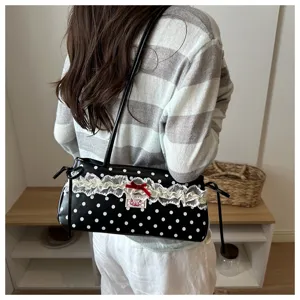 Chic black and white polka dot shoulder bag with cute lace trim and red bow for women.