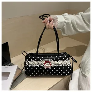 Black and white polka dot shoulder bag with delicate lace ruffles and cute bow detail.