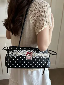 Chic black and white polka dot shoulder bag with sweet lace trim and elegant bow accent.