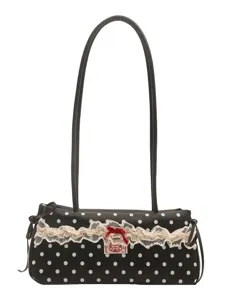 Chic black and white polka dot shoulder bag with delicate lace trim and red bow accent.