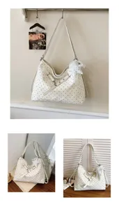 Detail of white polka dot tote bag, large capacity fashion shoulder bag for women.