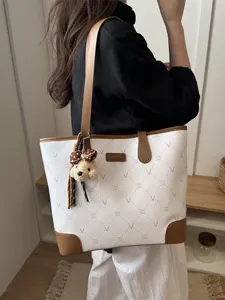 Large capacity women tote bag stylish commuter shoulder bag with cute bear pendant and chic design.