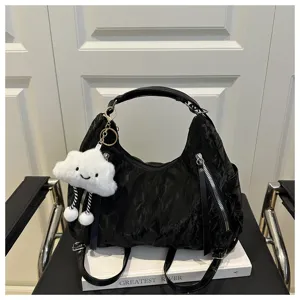 Black hobo shoulder bag detail, textured fabric, front zipper pockets and cute cloud charm.