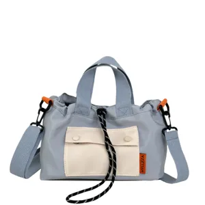 Casual women nylon crossbody shoulder bag with top handles and front pocket for daily use.